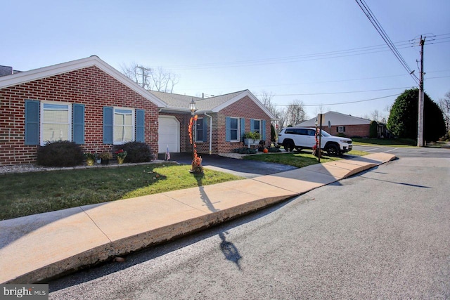 single story home featuring a garage and a front lawn