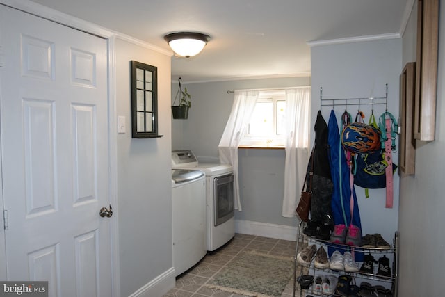 laundry room featuring crown molding, independent washer and dryer, and tile patterned floors