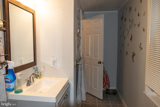 bathroom featuring crown molding, vanity, and tile patterned flooring