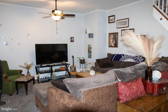 carpeted living room with crown molding and ceiling fan