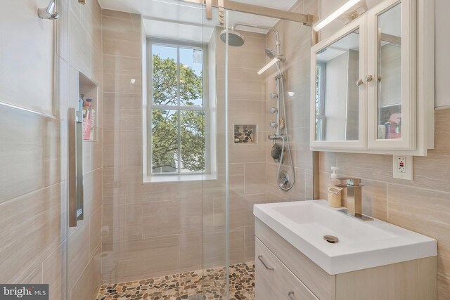 bathroom featuring an enclosed shower and vanity