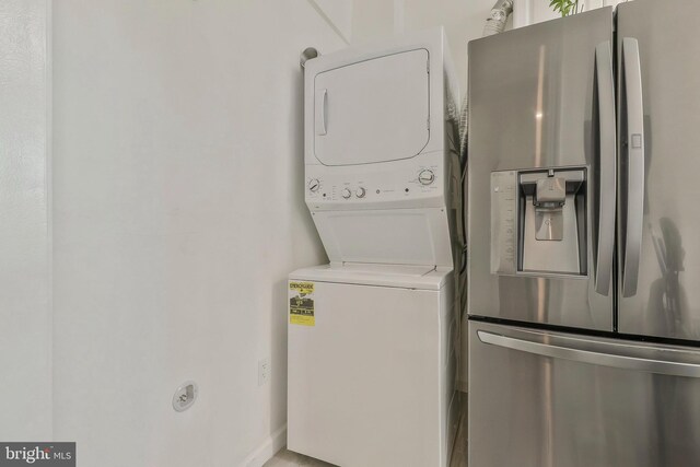 washroom featuring stacked washer / dryer