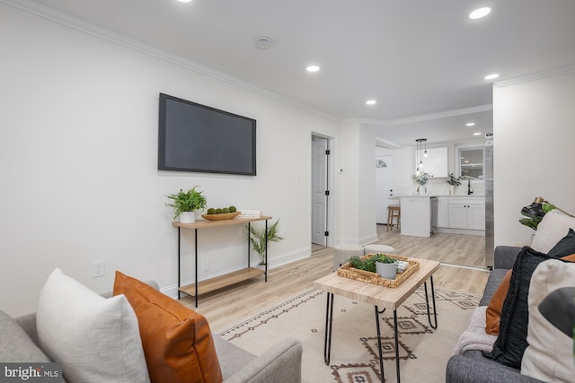 living room featuring light hardwood / wood-style floors and ornamental molding