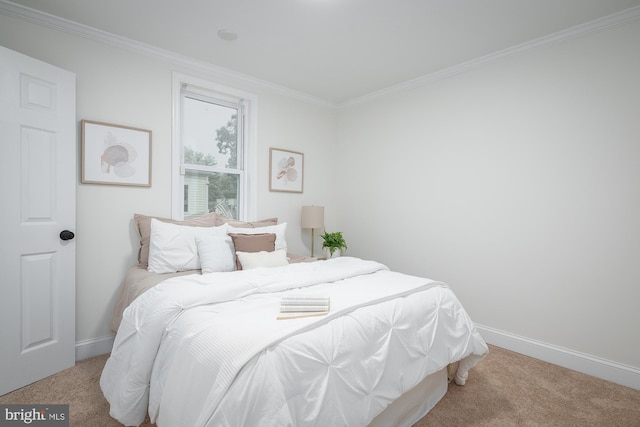 bedroom featuring crown molding and light carpet