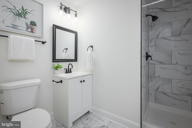 bathroom featuring vanity, toilet, and a tile shower