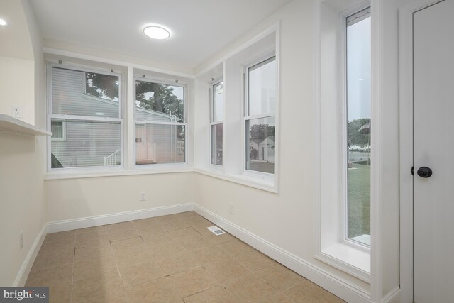 interior space featuring a healthy amount of sunlight and light tile patterned floors