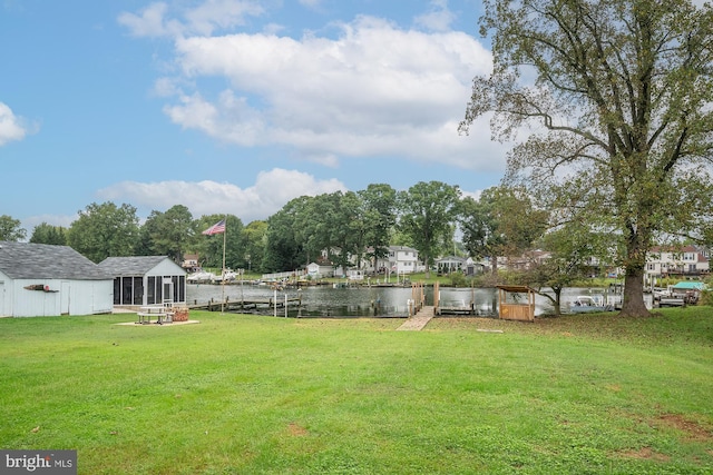 view of yard with a water view and a sunroom