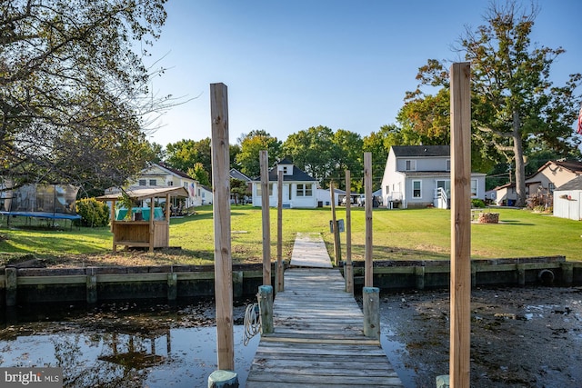 dock area featuring a water view and a lawn