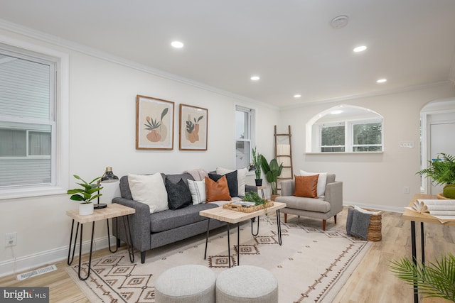 living room featuring light hardwood / wood-style floors and ornamental molding