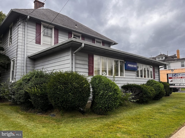 view of property exterior with a yard