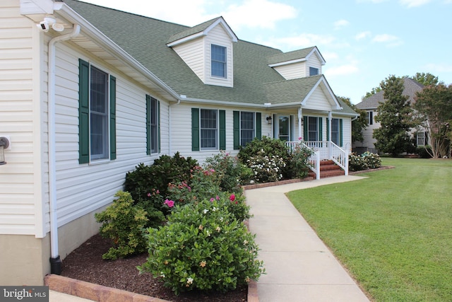 cape cod-style house featuring a front lawn and covered porch