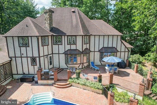 rear view of house with an outdoor hangout area and a patio area