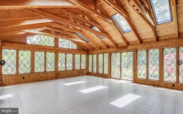 unfurnished sunroom with vaulted ceiling with skylight and a wealth of natural light