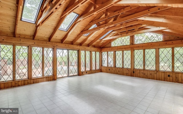 unfurnished sunroom with a wealth of natural light and vaulted ceiling with skylight