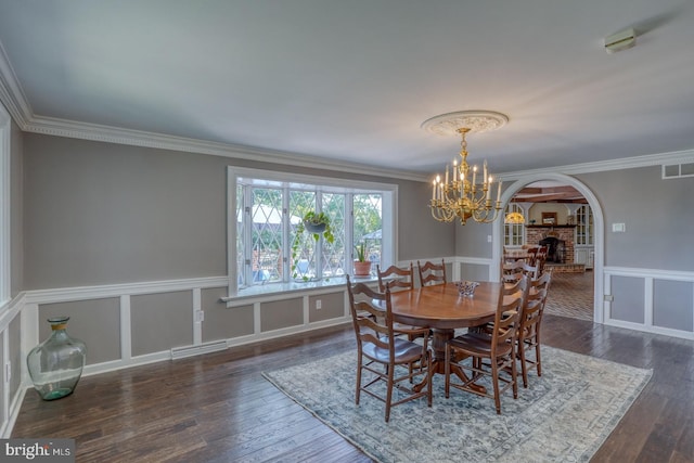 dining room featuring ornamental molding, dark hardwood / wood-style floors, and a chandelier