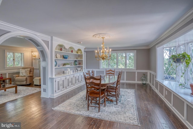 dining space featuring a wealth of natural light, dark wood-type flooring, and ornamental molding