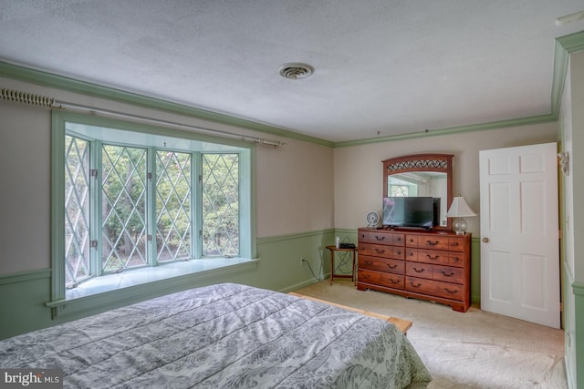 carpeted bedroom featuring a textured ceiling and crown molding