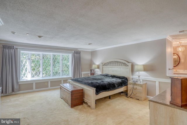 bedroom featuring a textured ceiling, light carpet, and ornamental molding