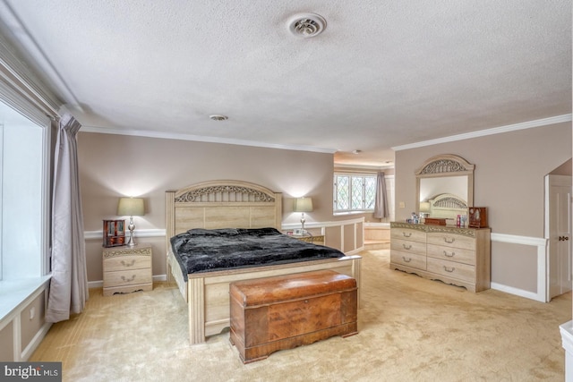 carpeted bedroom with crown molding and a textured ceiling