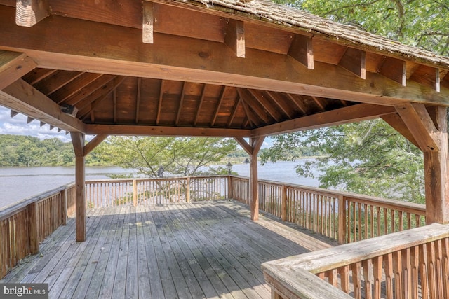 wooden deck with a water view and a gazebo