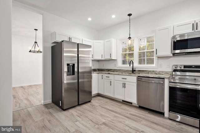 kitchen with sink, appliances with stainless steel finishes, and white cabinetry