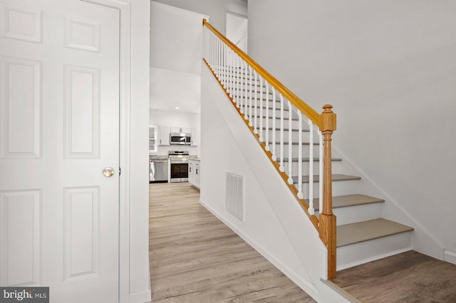 staircase featuring hardwood / wood-style flooring