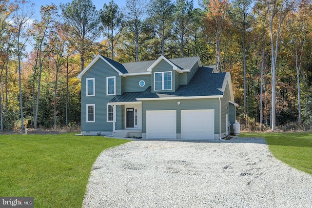 view of front of home featuring a garage, driveway, a front yard, and a shingled roof