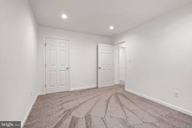 unfurnished bedroom featuring recessed lighting, baseboards, and carpet floors