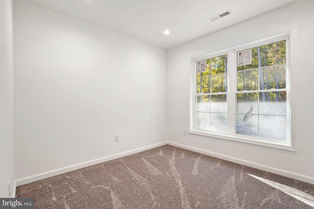 unfurnished room featuring recessed lighting, visible vents, baseboards, and carpet