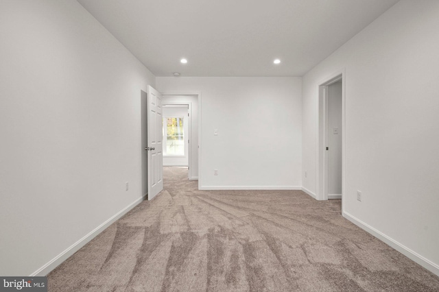 empty room featuring recessed lighting, baseboards, and carpet floors