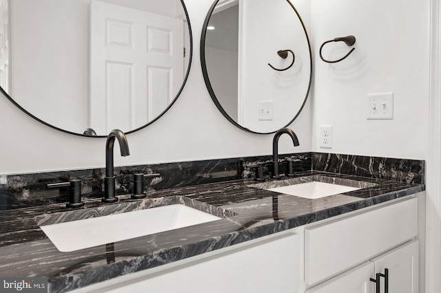 full bath featuring double vanity and a sink