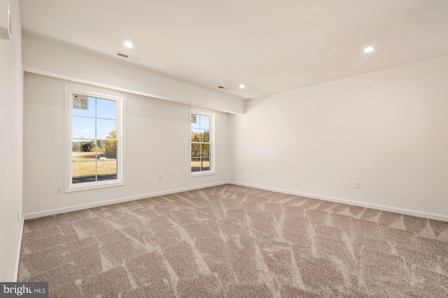 carpeted empty room with recessed lighting, baseboards, and visible vents