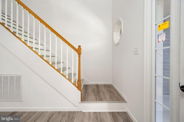 staircase with hardwood / wood-style flooring