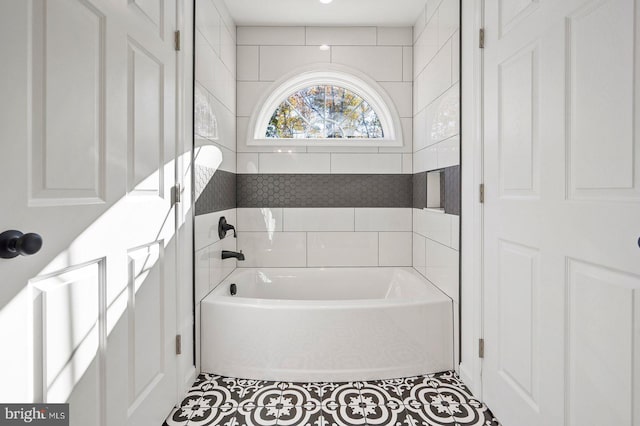 bathroom with tile patterned flooring and a bathing tub