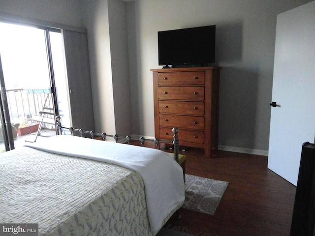 bedroom featuring access to outside, baseboards, and wood finished floors