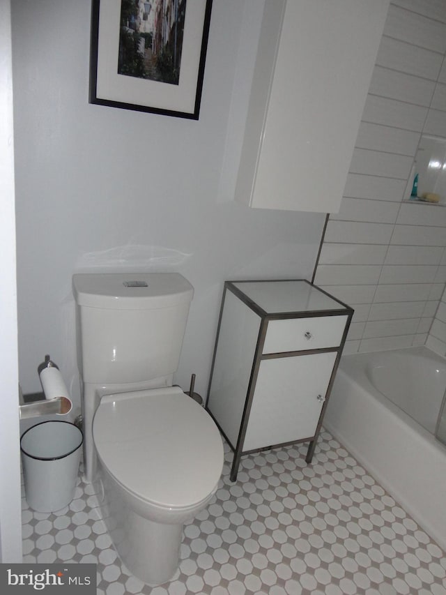 full bathroom with a bathing tub, toilet, and walk in shower