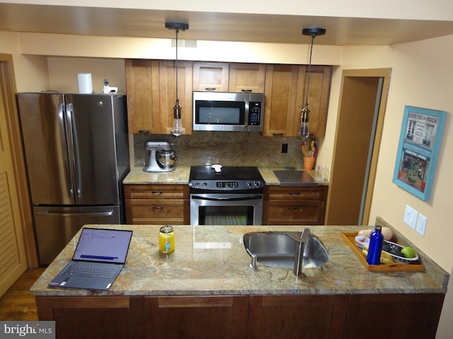 kitchen with appliances with stainless steel finishes, light stone counters, and decorative backsplash