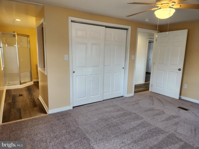 unfurnished bedroom with ceiling fan, carpet, a closet, and baseboards