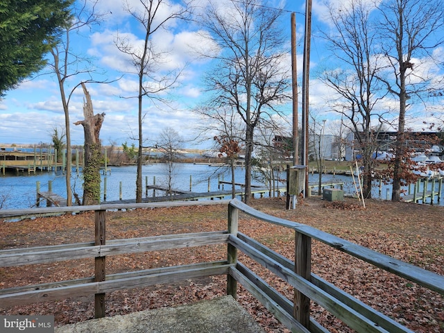 view of yard with a dock and a water view