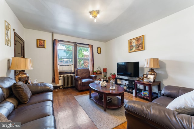 living room featuring cooling unit, radiator heating unit, and dark hardwood / wood-style floors