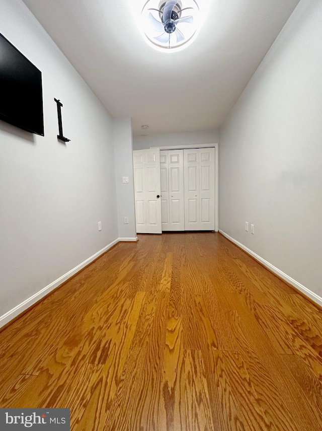 unfurnished bedroom with hardwood / wood-style floors and a closet