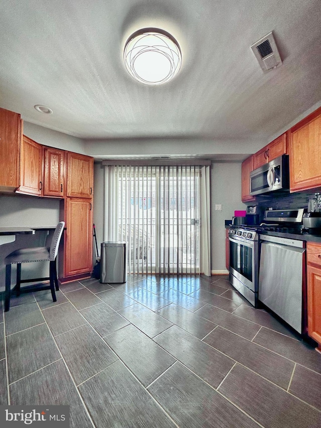 kitchen featuring appliances with stainless steel finishes and a textured ceiling