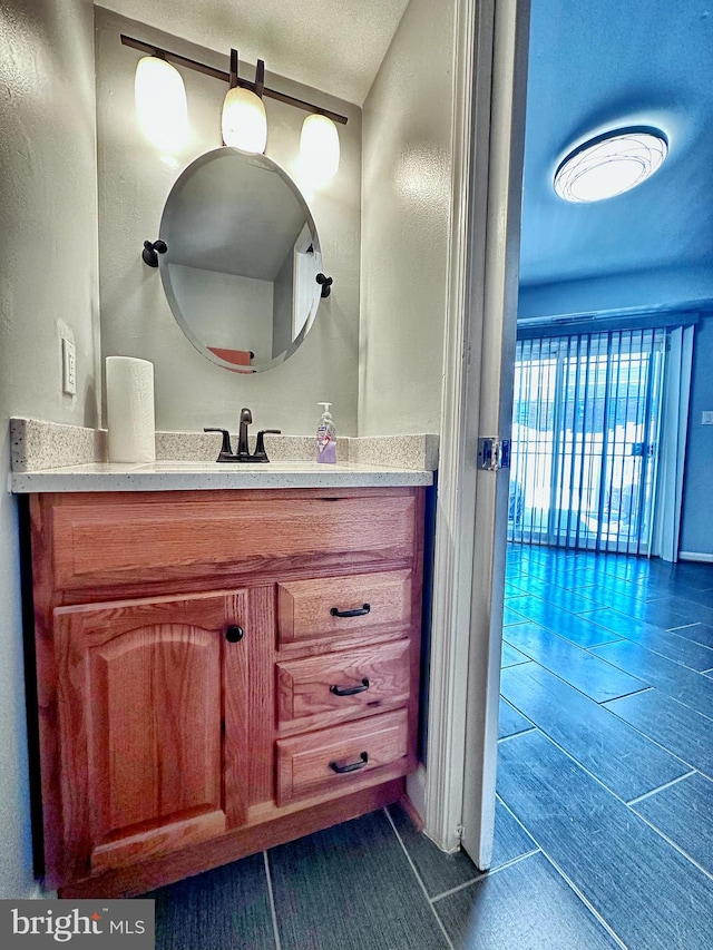 bathroom with a textured ceiling and vanity