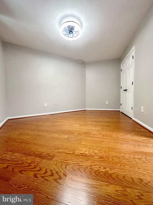 empty room with hardwood / wood-style flooring