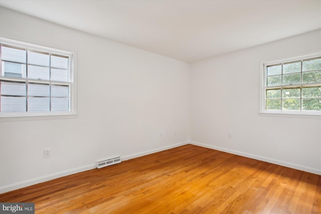 unfurnished room with wood-type flooring