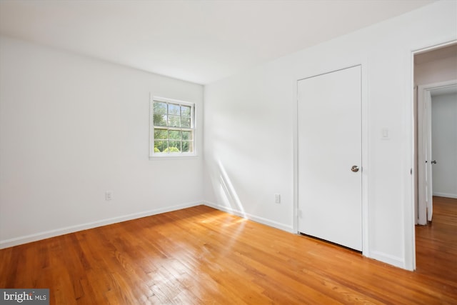 unfurnished bedroom with hardwood / wood-style flooring