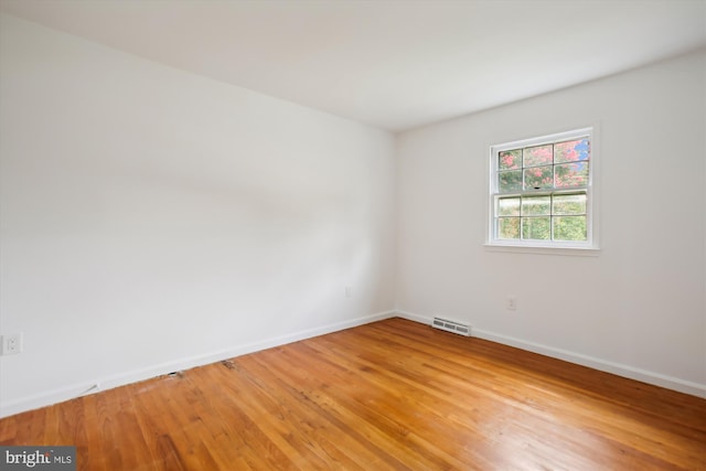 unfurnished room with hardwood / wood-style floors