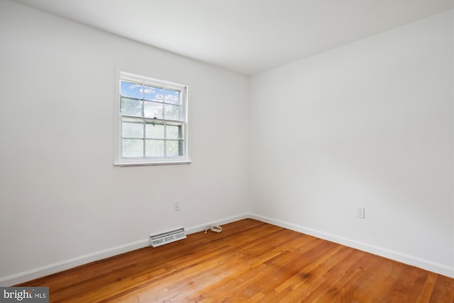 spare room featuring wood-type flooring