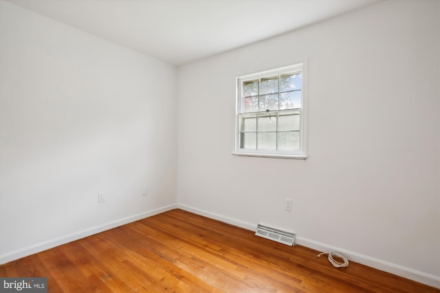 spare room with wood-type flooring