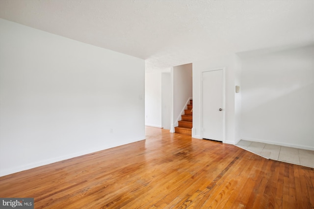 empty room with hardwood / wood-style floors